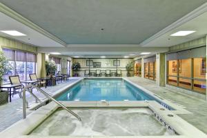 a pool in a hotel room with a hot tub at Hampton Inn & Suites Guelph in Guelph
