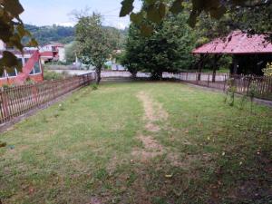 un patio con una valla y un campo de hierba en Vila Goca, en Gornja Trepča