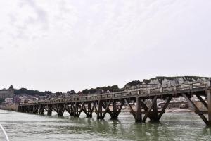 a bridge over the water with a train on it at La Capitainerie in Le Tréport +2 photos