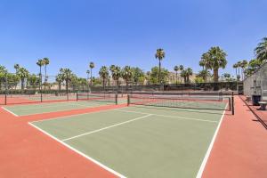 a couple of tennis courts with palm trees at Retro-Inspired Palm Springs Condo with Pool View! in Palm Springs