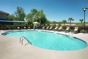 a large swimming pool with chairs around it at Hampton Inn Hilton Head in Hilton Head Island