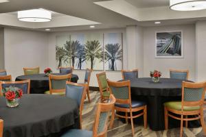 a conference room with tables and chairs and paintings at Hampton Inn Hilton Head in Hilton Head Island +20 photos