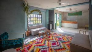 a living room with a couch and a rug at Turquoise Tulum Hotel in Tulum