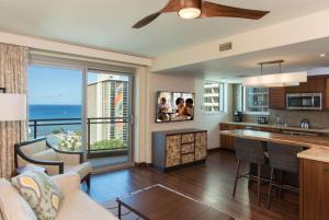 a kitchen and living room with a view of the ocean at Hilton Grand Vacation Club The Grand Islander Waikiki Honolulu in Honolulu