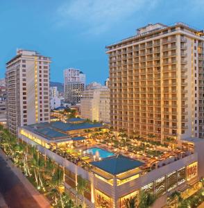 un gran edificio con piscina frente a una ciudad en Embassy Suites by Hilton Waikiki Beach Walk, en Honolulu
