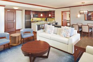 a living room with a couch and a table at Hilton Grand Vacations Club Grand Waikikian Honolulu in Honolulu