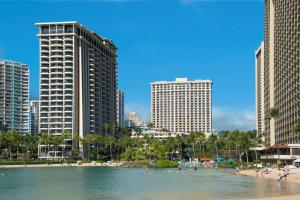 a beach in a city with tall buildings at Hilton Grand Vacations Club at Hilton Hawaiian Village in Honolulu