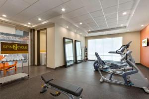 a gym with a treadmill and a elliptical bike in a room at Home2 Suites by Hilton Houston Stafford - Sugar Land in Stafford