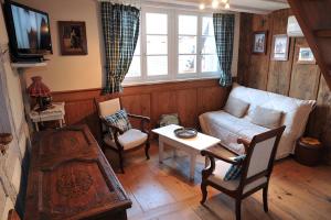 a living room with a couch and a table at Gite Chez Marcel in Riquewihr