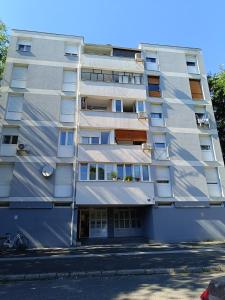 an apartment building with balconies on a street at Studio apartman Peti in Varaždin