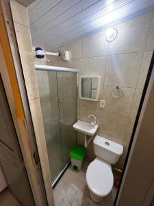 a small bathroom with a toilet and a sink at Kitnets Itapuã Residência - 1 Minuto de Caminhada Ate a Praia in Salvador