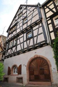 an old building with a large wooden door at Gite Chez Marcel in Riquewihr