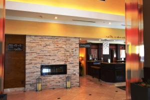 a lobby with a brick fireplace in a building at Hilton Garden Inn Houston West Katy in Katy