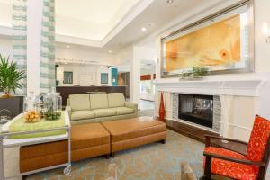 a living room with a couch and a fireplace at Hilton Garden Inn Nanuet in Nanuet