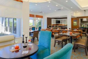 a restaurant with blue chairs and tables and a bar at Hilton Garden Inn Nanuet in Nanuet