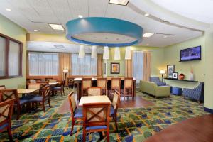 a dining room with tables and chairs and a blue ceiling at Hampton Inn High Point in Archdale