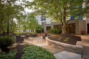 a courtyard with tables and chairs and a building at Hampton Inn by Hilton Harrisburg West in Mechanicsburg