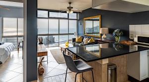 a kitchen and living room with a view of the ocean at Cosy Sky View Apartment in Ballito