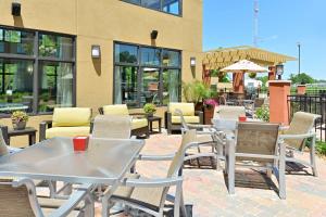 a patio with tables and chairs in front of a building at Homewood Suites by Hilton Houma in Houma