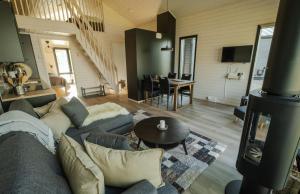 a living room with a couch and a wood stove at Norlight Cottages Ivalo - Aurinko East in Ivalo