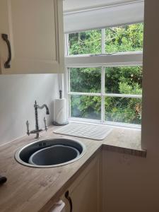 a sink in a kitchen with a window at Beachglass in Lynton