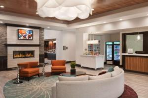a lobby with a couch and chairs and a fireplace at Homewood Suites by Hilton North Houston/Spring in Spring