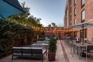 an outdoor patio with tables and chairs and lights at Hampton Inn Wilmington University Area in Wilmington
