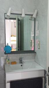 a bathroom with a sink and a mirror at les pieds dans l'eau in Les Boucholeurs