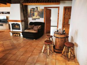 a living room with a couch and a barrel and stools at FeWo Pfälzer Felsenlandschaft in Pirmasens