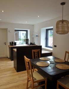 a dining room and kitchen with a table and chairs at Ferienwohnung Natters - Your vacation base in Innsbruck