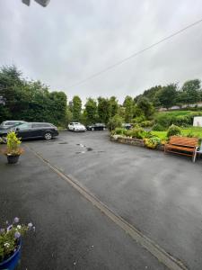 a parking lot with several cars parked in it at Double bed Small En-suite for 2 in Killybegs