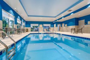 a swimming pool in a hotel with blue walls at Hampton Inn Bedford In, In in Bedford