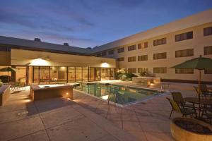 a hotel with a swimming pool and a building at Homewood Suites by Hilton Indianapolis Carmel in Carmel