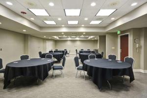 a conference room with black tables and chairs in it at Homewood Suites by Hilton Indianapolis Carmel in Carmel