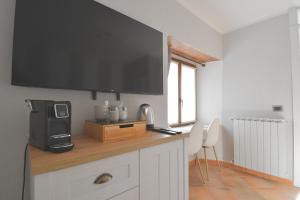 a kitchen with a counter with a television on it at Baceno Room in Baceno