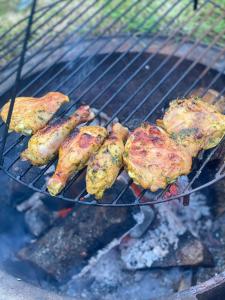 a bunch of food cooking on a grill at Willowbank shepherds hut in Taunton +18 photos