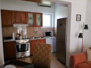 a kitchen with a stove and a refrigerator at Apartment Casa sul Mare in Tivat