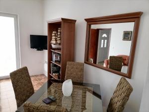 a dining room with a table and a mirror at Apartment Casa sul Mare in Tivat
