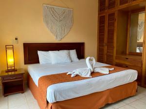 a hotel room with a bed with towels on it at Quinta Sea in Playa del Carmen