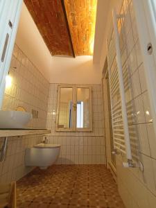 a bathroom with a tub and a sink and a mirror at AFFITTACAMERE SobborgoSpina47 in Sarzana +38 photos