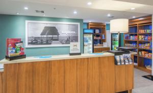 a library with a reception counter in a store at Hampton Inn Jacksonville South/I-95 at JTB in Jacksonville