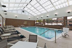 a swimming pool with a skylight in a building at Doubletree By Hilton Jamestown, Ny in Jamestown