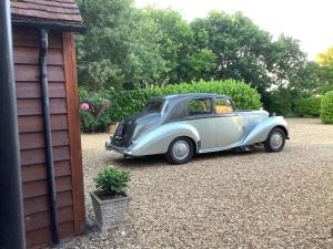a silver and black car parked next to a building at The Oak Lodge, Clematis Cottages, Stamford in Stamford