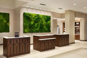 a lobby with a green painting on the wall at Embassy Suites By Hilton Oahu Kapolei - FREE Breakfast in Kapolei