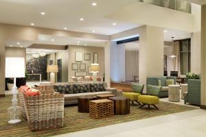 a lobby with a couch and tables and chairs at Embassy Suites By Hilton Oahu Kapolei - FREE Breakfast in Kapolei