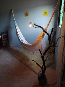 a hammock hanging from a wall in a room at Hostel do Cerrado in Cavalcante