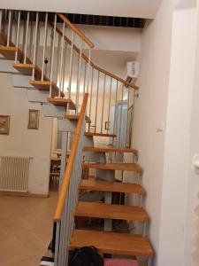 uma escada numa casa com degraus de madeira em La Casa sull'argine 2 em Sarzana