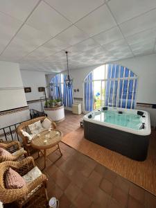 a living room with a large tub in a room at Casa Maria in Camuñas