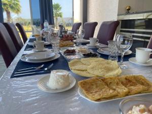 a table with plates of food on top of it at Chambres d hotes Villa 
