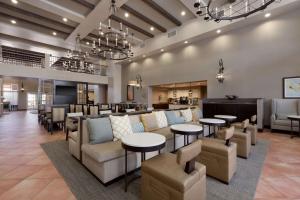 a lobby with couches and tables and a bar at Homewood Suites by Hilton La Quinta in La Quinta